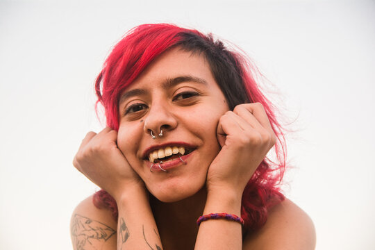 Latino nonbinary person smiling 