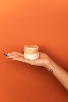 Hispanic woman holding handmade soap