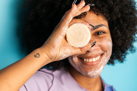 Hispanic woman displaying handmade soap