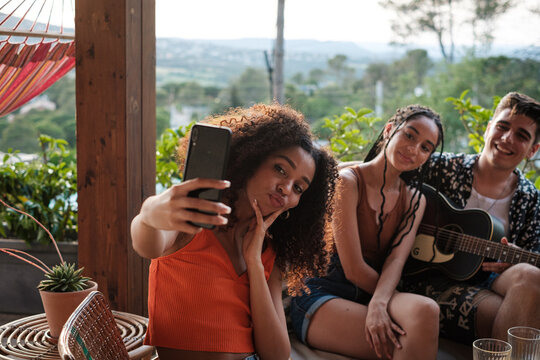 Woman taking a selfie with friends outdoors