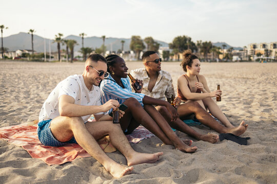 Happy multi-ethnic friends having a great day at the beach