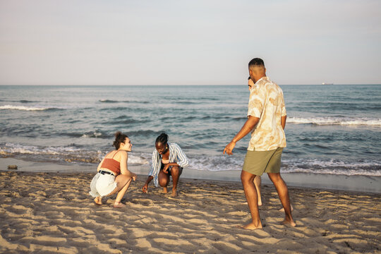 Happy multi-ethnic friends having a great day at the beach