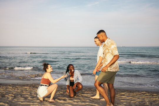 Happy multi-ethnic friends having a great day at the beach