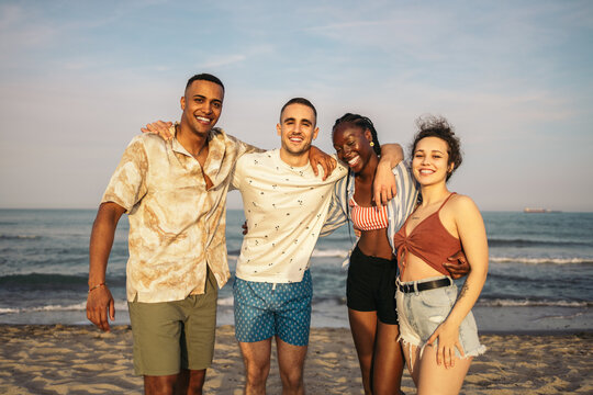 Happy multi-ethnic friends having a great day at the beach