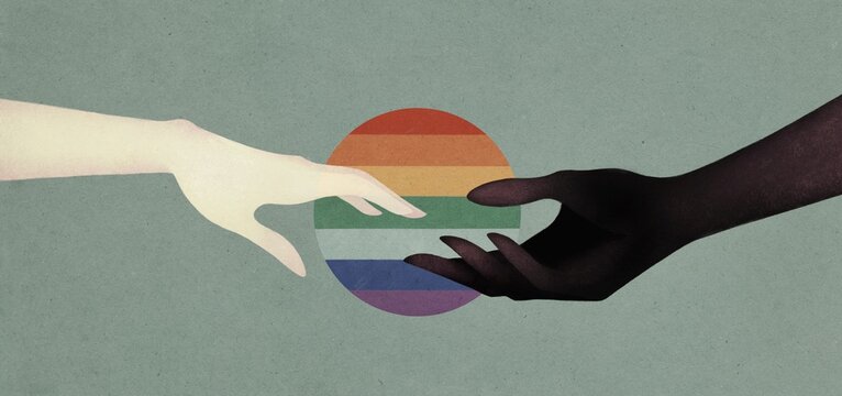 two hands on a rainbow flag