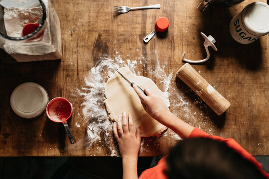 boy cutting shortbread dough for Christmas 
