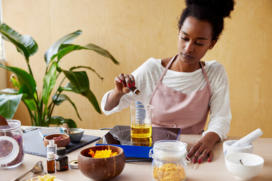 Black woman dripping essence into oil
