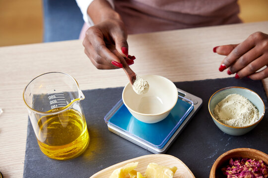 Cropped woman measuring natural cosmetics ingredients