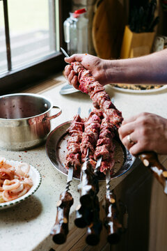 Man prepares meat for cooking.