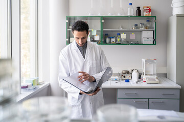 Scientist Holding Folder In The Lab