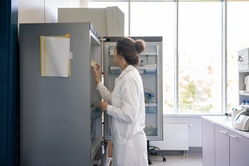 Woman Taking Sample From Refrigerator In The Lab