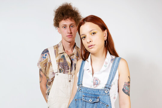 Young man and woman dressed in overalls