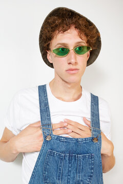 Portrait of young man with curly blond hair wearing white t-shirt