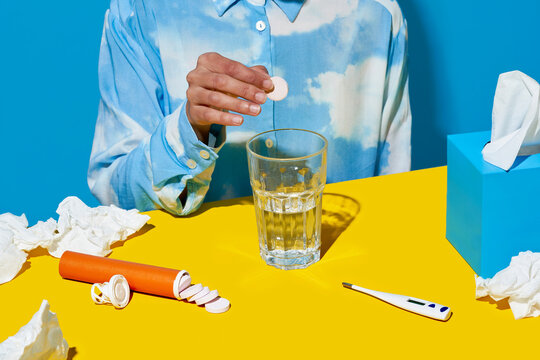 Crop sick woman taking carbon tablets