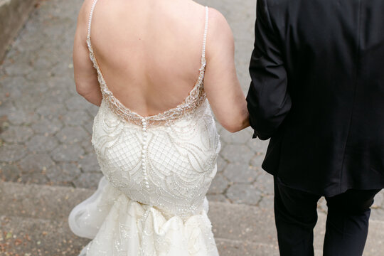 A Bride and Groom Walking Down Stairs