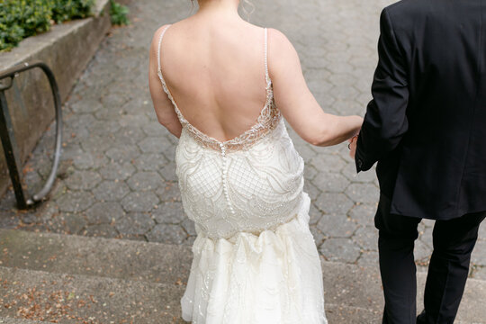 A Couple Walks down Stairs at their Wedding