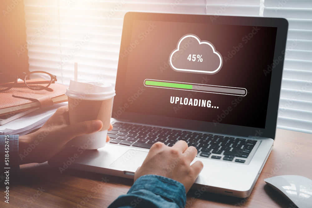 Poster upload data concept, woman using laptop computer and waiting for cloud uploading on laptop in office