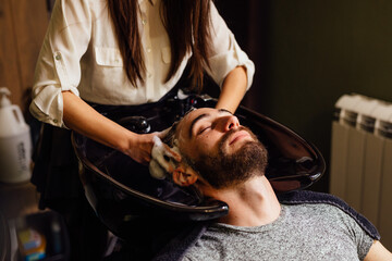 Woman washing hair at hair salon