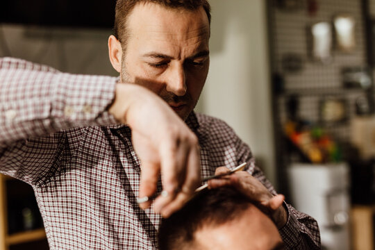 Portrait of barber cutting hair