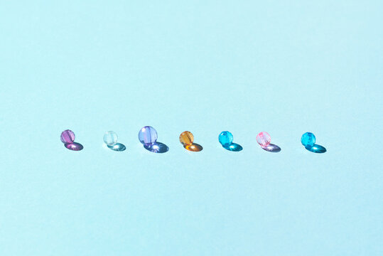 Shiny Colored Beads On Light Blue Background