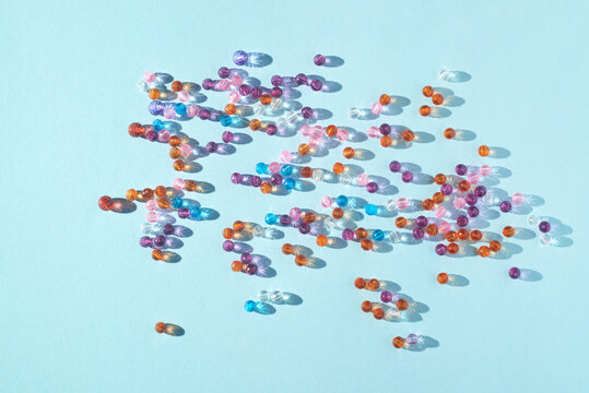 Scattered Colored Beads On Light Blue Background