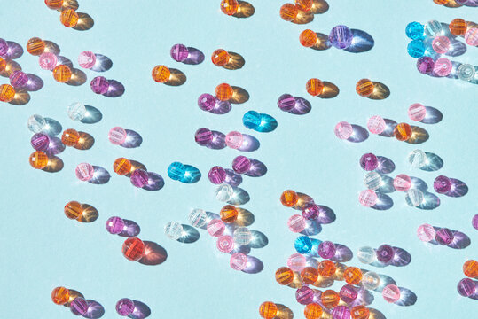 Colored Beads Scattered On Light Blue Background
