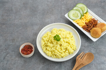 Nasi kuning, Indonesian traditional food, made from rice cooked with turmeric and coconut milk and spices.
