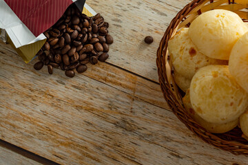 top view of brazilian cheesebread, or 'pão de queijo' with coffee beans over table. copy space