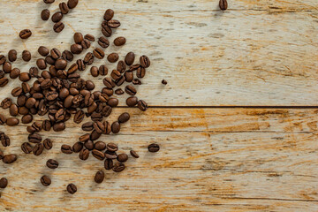 coffee beans over wooden table, with copy space or text area