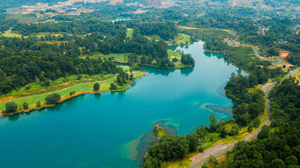 Aerial drone view of lake scenery with turquoise water in Tasik Puteri, Bukit Besi, Terengganu, Malaysia.
