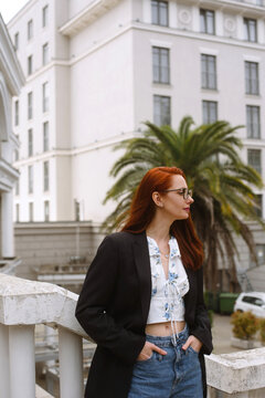 Redhead woman wearing glasses and looking away