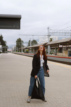 Cheerful woman walking at the train station