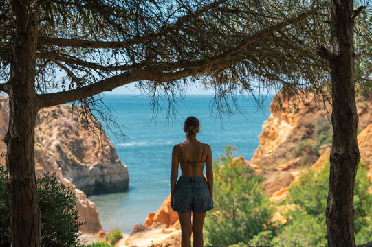 Woman admiring view of sea from cliff