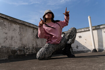 young woman hip hop dance on the roof