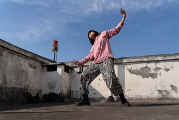 young woman hip hop dance on the roof