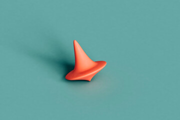 a pink spinning top on a blue background