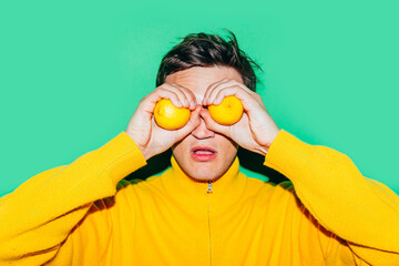 Man in Yellow Holding Lemons