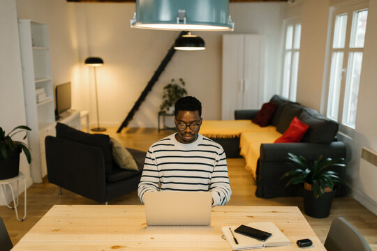 Millennial male working working online from home