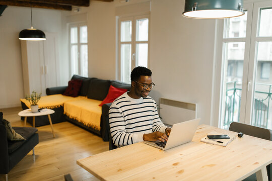 Smiling man working working online from home
