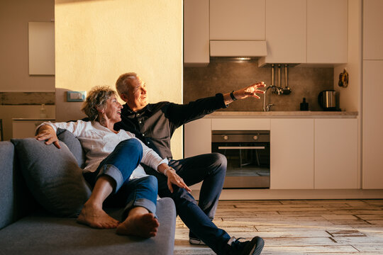 Mature couple sitting on the sofa - Powered by Adobe