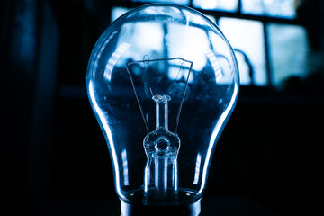 Glass light bulb close-up in a dark room