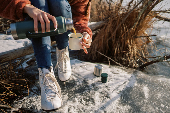 woman with ice skates pouring a hot drink