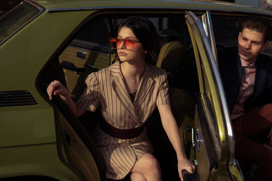 A stylish couple inside a car