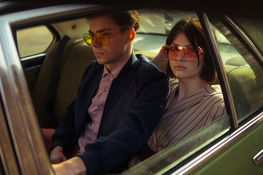A stylish couple inside a car