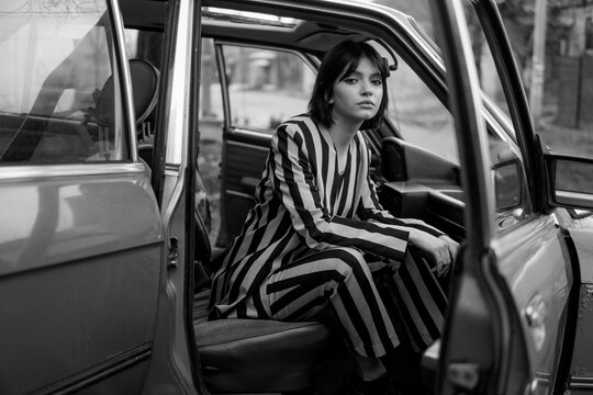 Stylish Woman sitting in the old car