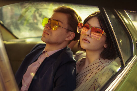 A stylish couple inside a car