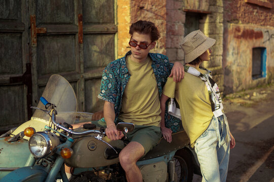 A stylish couple on the vintage motorcycle