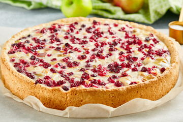 Sweet bakery - cranberry pie with apple on gray stone background. Lingonberry pie  in rustic style...