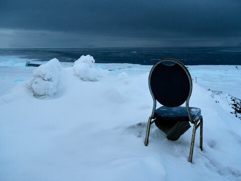 Greenland Arctic polar night - old seat, chair in snowy landscape