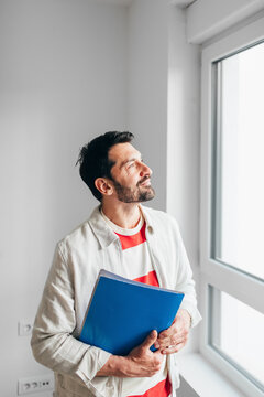 Real Estate Agent Looking Through Window
